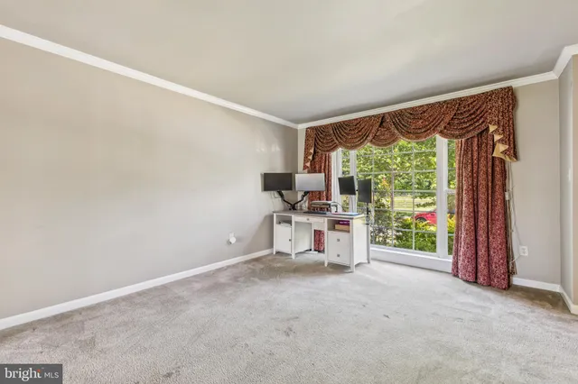 a view of a room with a floor to ceiling window and an outdoor view