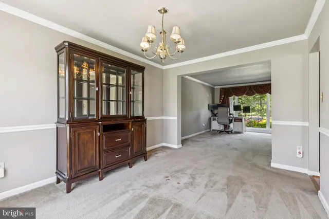 a view of a livingroom with furniture hardwood floor and windows