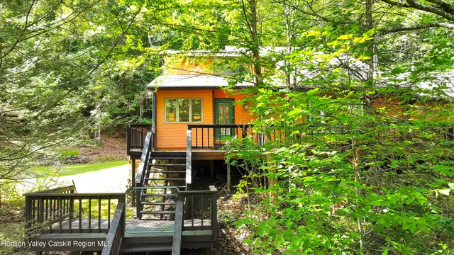 front view of a house with a tree