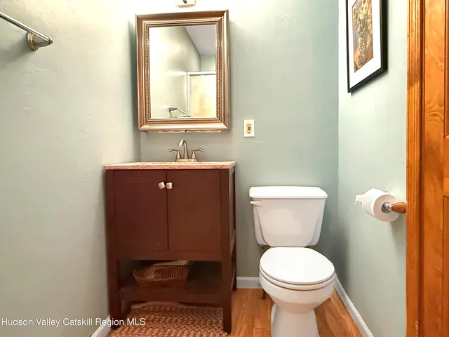 a bathroom with a toilet a sink and mirror