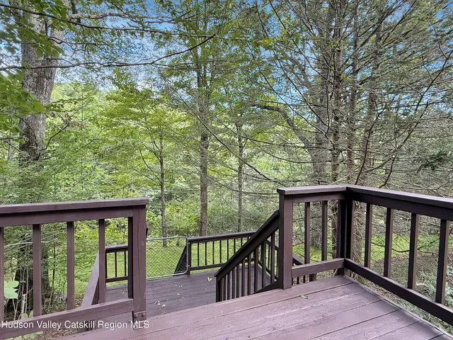 a view of a balcony with wooden floor and fence