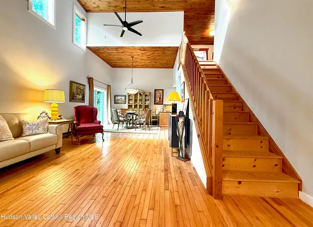 a view of a livingroom with furniture wooden floor and windows