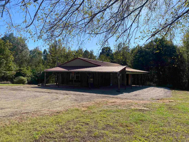 a front view of house with yard and trees