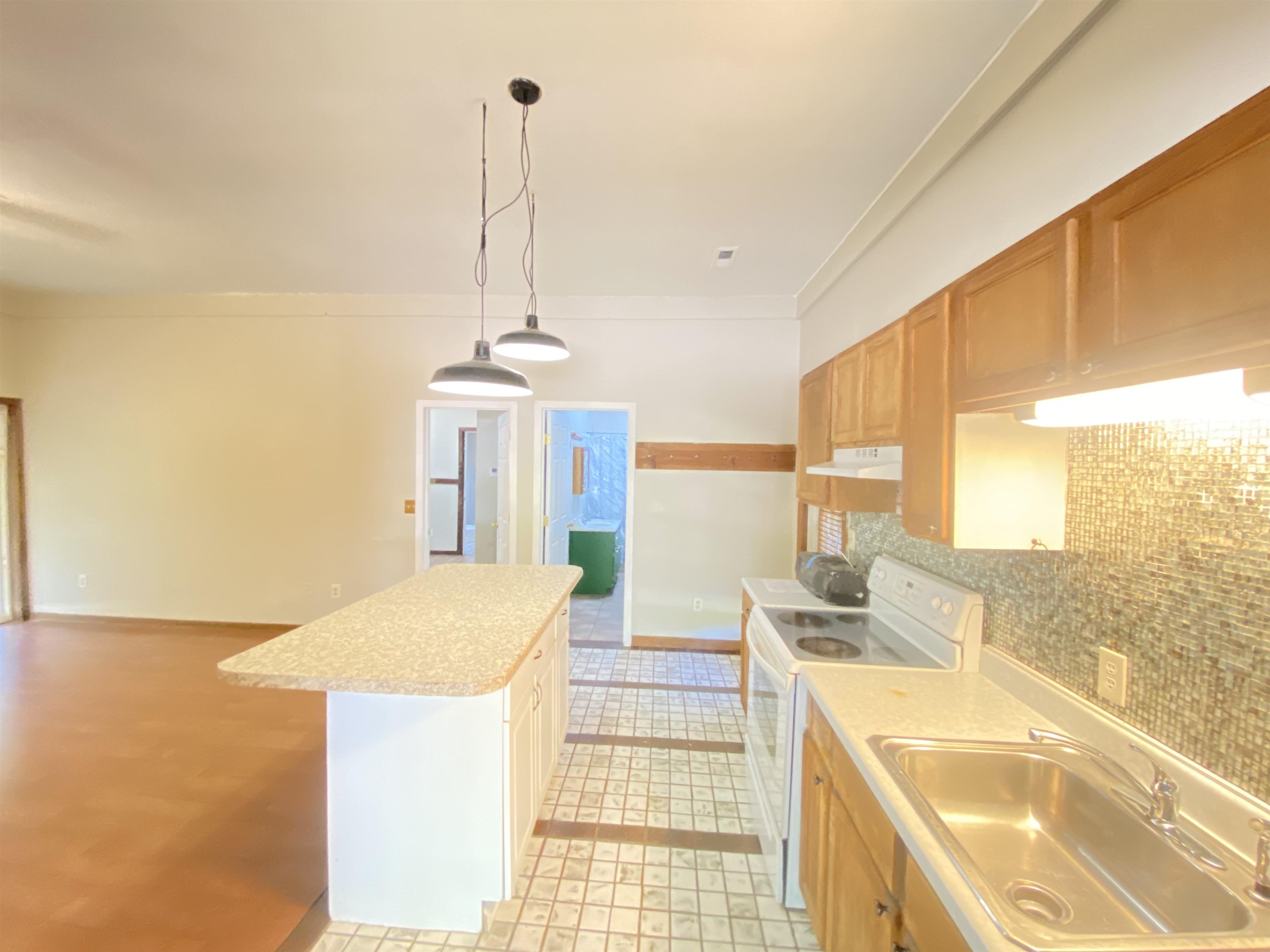 5610 Leapwood Enville Road Adamsville, TN 38310 - Photo 14 of 27 a kitchen with a sink stove and cabinets