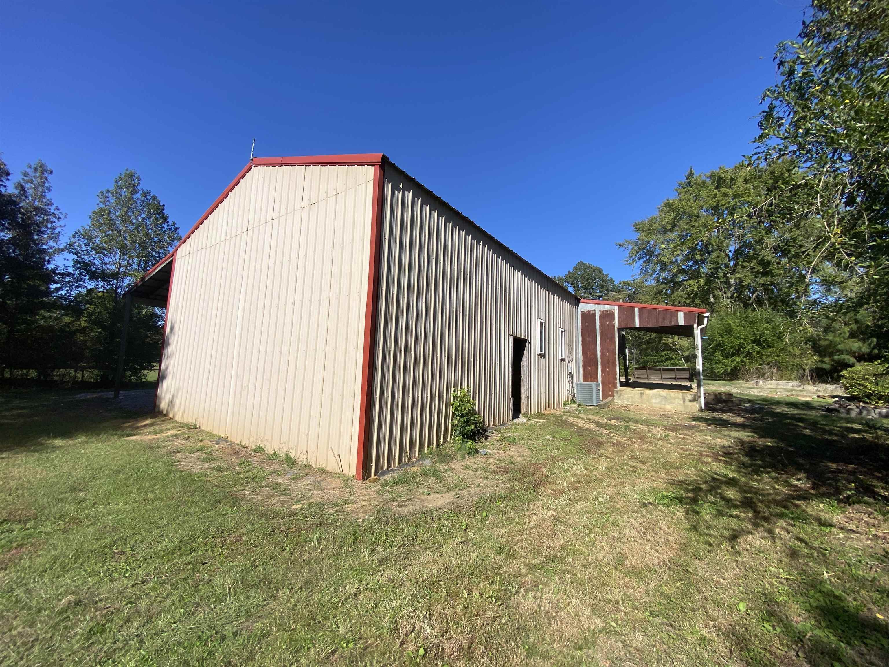 5610 Leapwood Enville Road Adamsville, TN 38310 - Photo 22 of 27 a view of a house with backyard and trees
