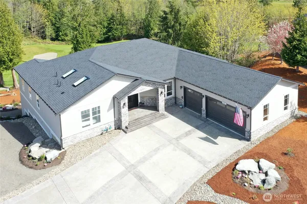 a aerial view of a house with a yard