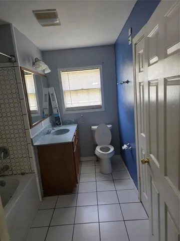 a bathroom with a sink toilet and mirror