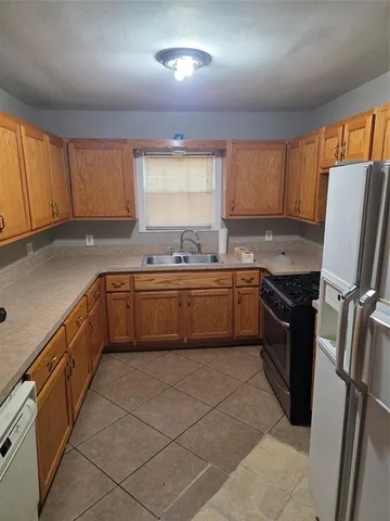 a kitchen with a sink a stove and cabinets
