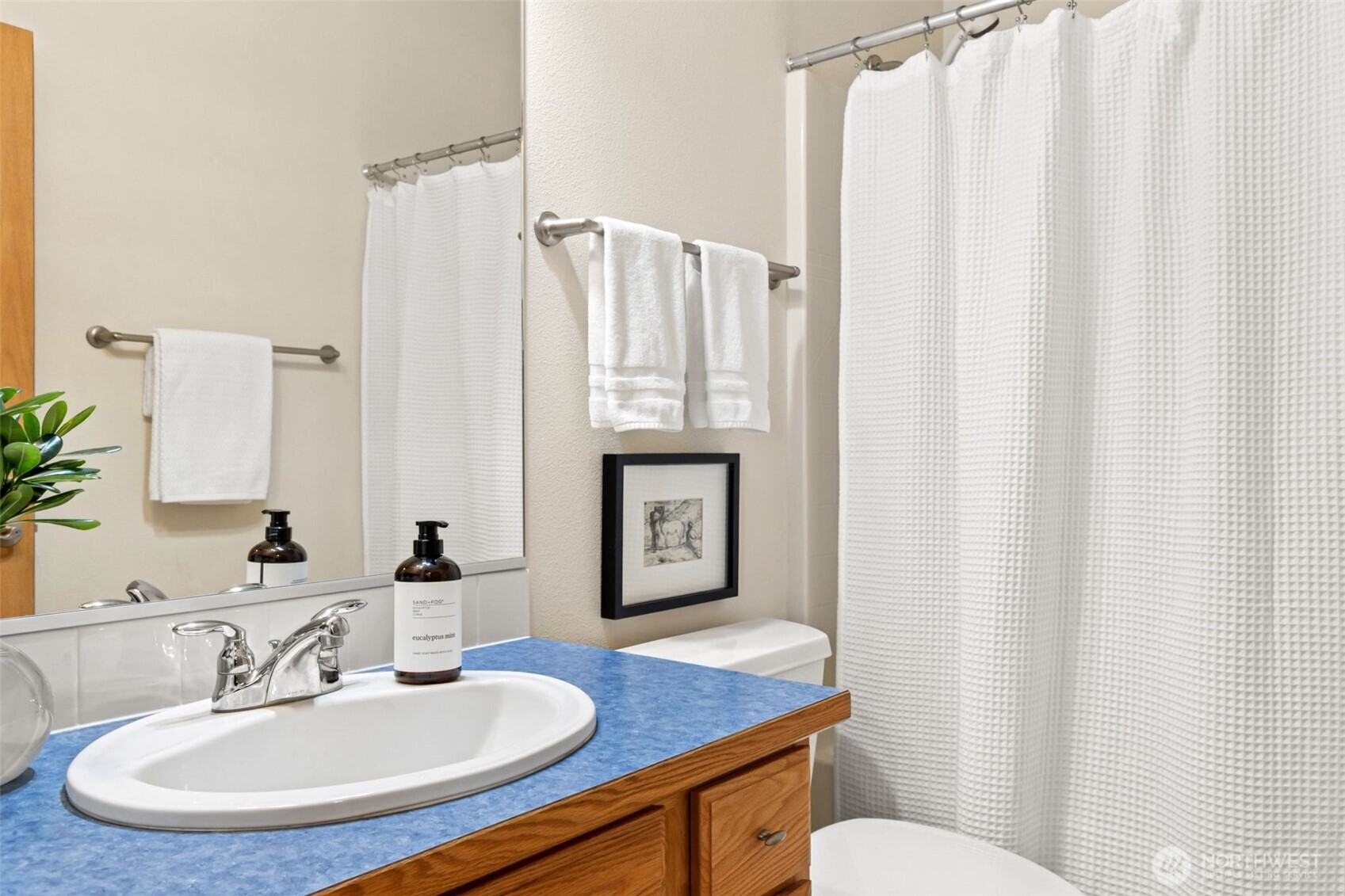 8232 Bainbridge Loop Northeast Lacey, WA 98516 - Photo 15 of 37 a bathroom with a toilet a sink and a mirror