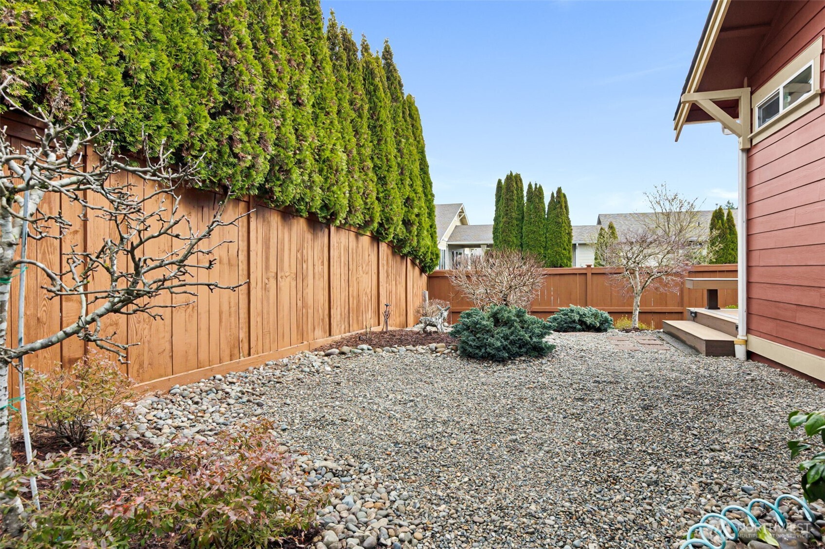 8232 Bainbridge Loop Northeast Lacey, WA 98516 - Photo 19 of 37 a backyard of a house with lots of green space