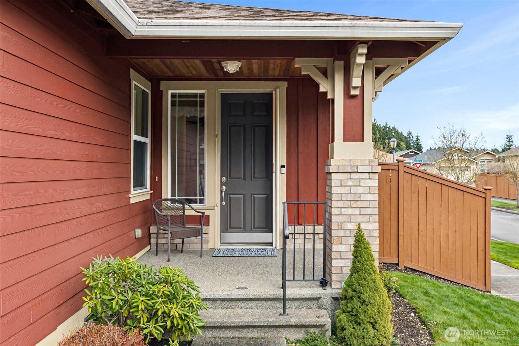 8232 Bainbridge Loop Northeast Lacey, WA 98516 - Photo 2 of 37 a view of a wooden door with a bench