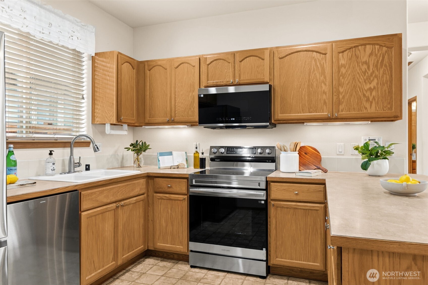8232 Bainbridge Loop Northeast Lacey, WA 98516 - Photo 10 of 37 a kitchen with a sink stove and microwave