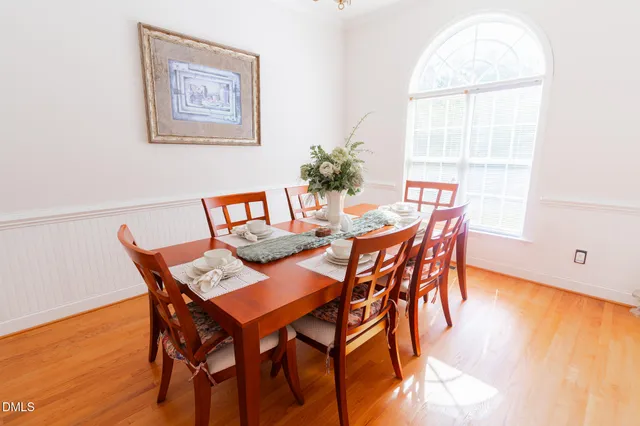 a view of a dining room with furniture and wooden floor