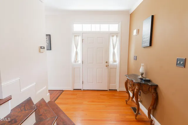 a view of a dining room with furniture and wooden floor