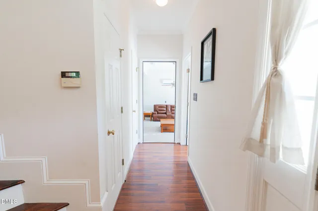 a view of entryway and hall with wooden floor