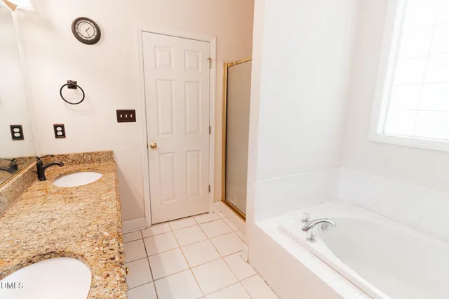 a view of walk in closet with clothes