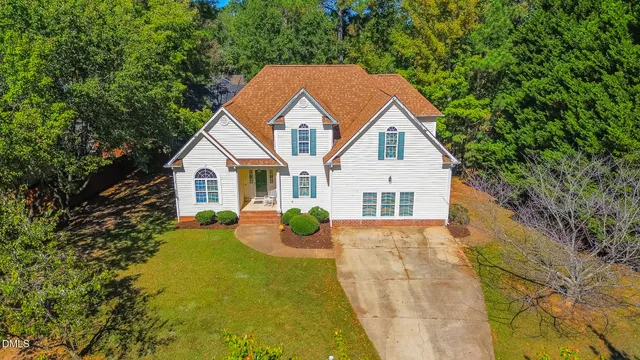 an aerial view of a house with a yard