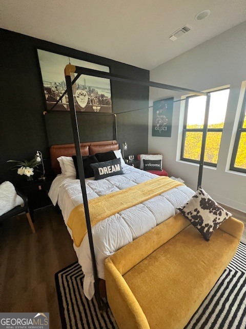 112 Rogers Street Southeast, Unit 504 Atlanta, GA 30307 - Photo 2 of 14 a bedroom with a bed and wooden floor