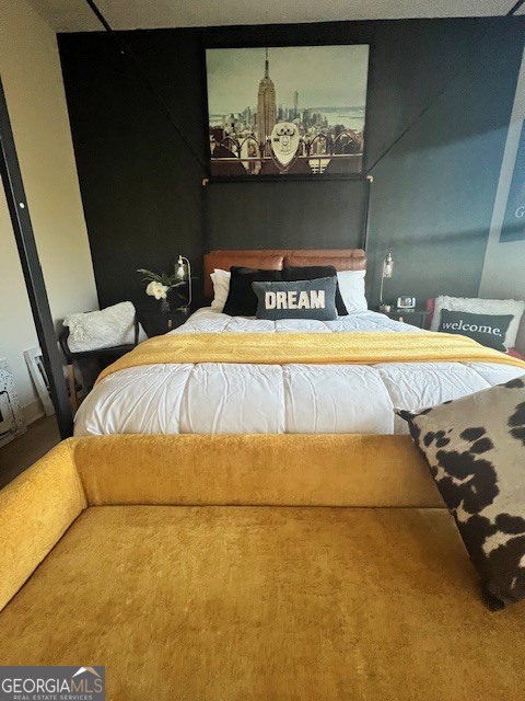 112 Rogers Street Southeast, Unit 504 Atlanta, GA 30307 - Photo 8 of 14 a bedroom with a bed and a painting on the wall