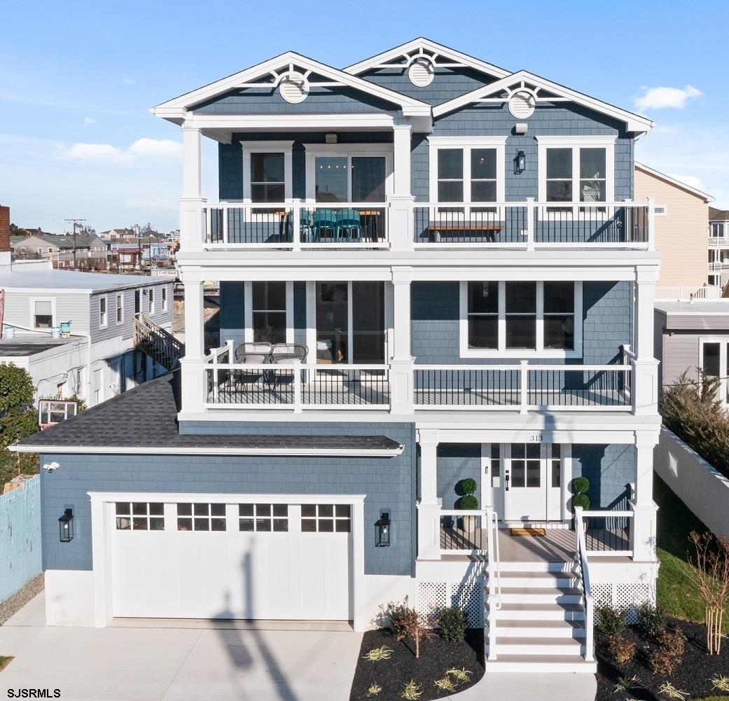 a front view of a building with a garden and balcony