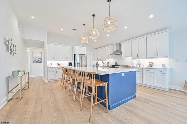 a living room with furniture a fireplace and a chandelier