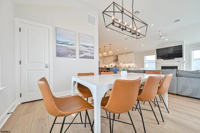 a living room with furniture and a dining table