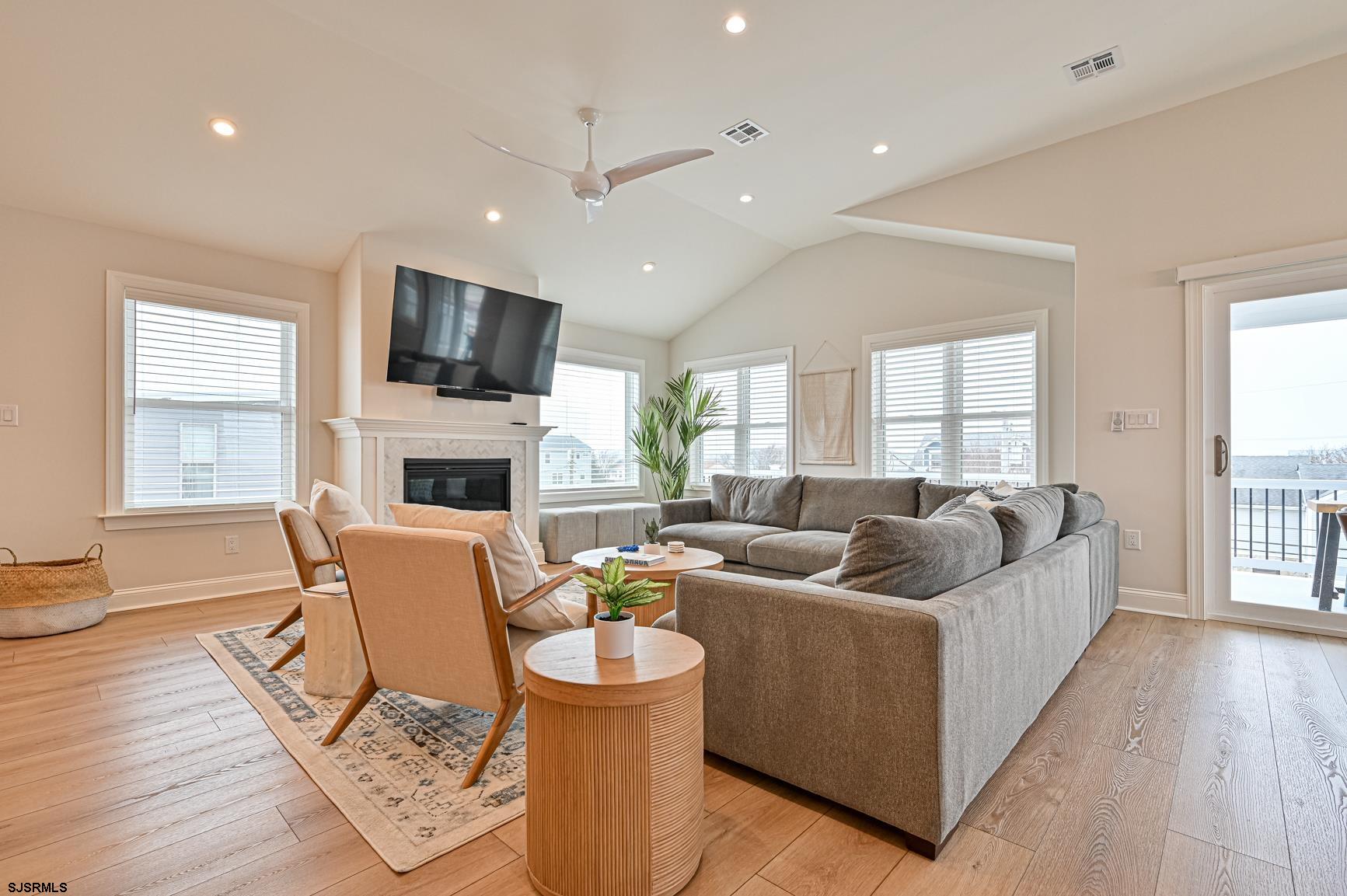 251 38th Street South Brigantine, NJ 08203 - Photo 21 of 63 a living room with fireplace furniture and a wooden floor