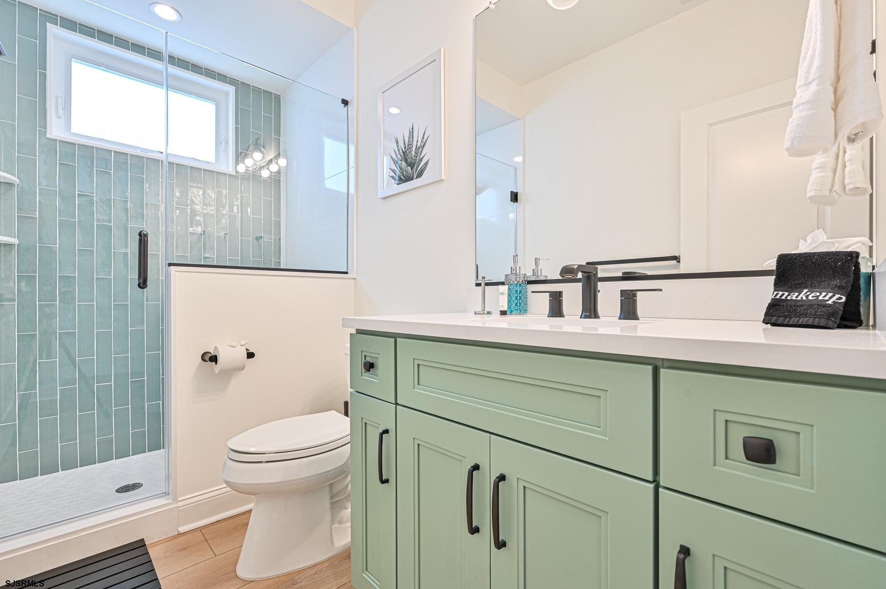251 38th Street South Brigantine, NJ 08203 - Photo 24 of 63 a bathroom with a double vanity sink toilet and shower