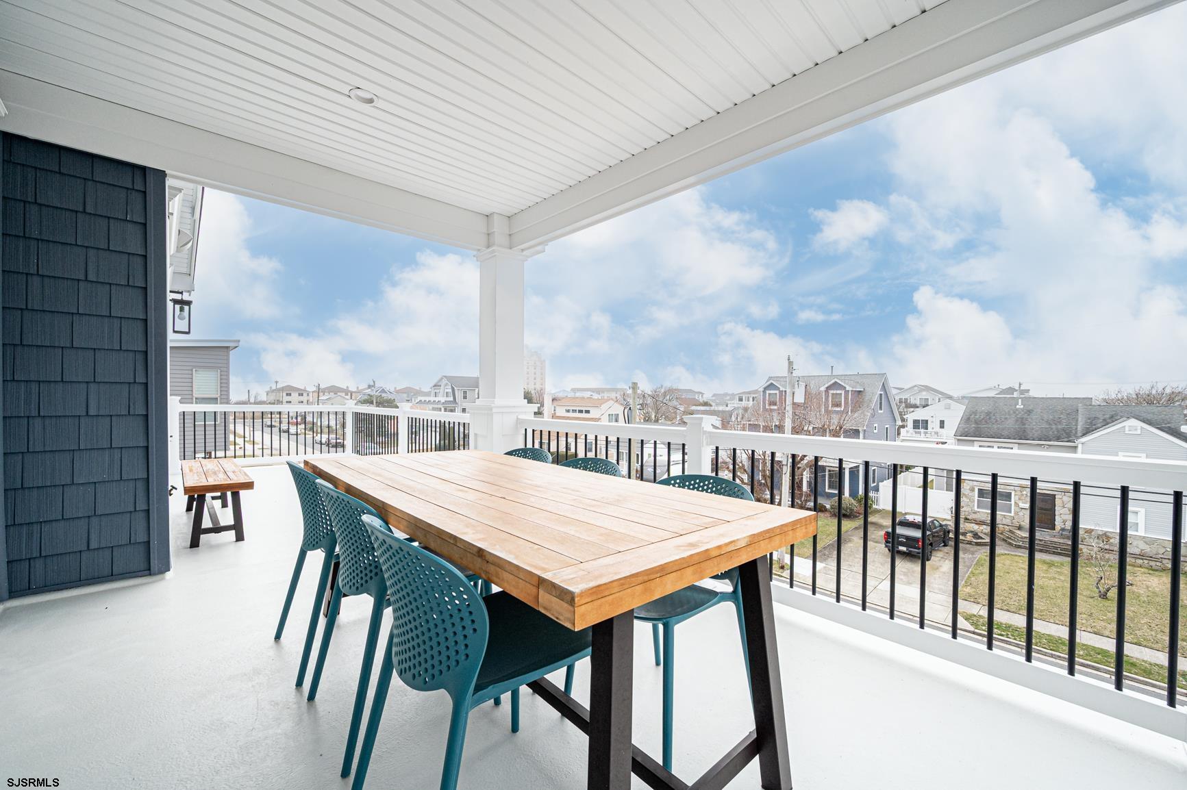 251 38th Street South Brigantine, NJ 08203 - Photo 30 of 63 a view of a balcony dining table and chairs
