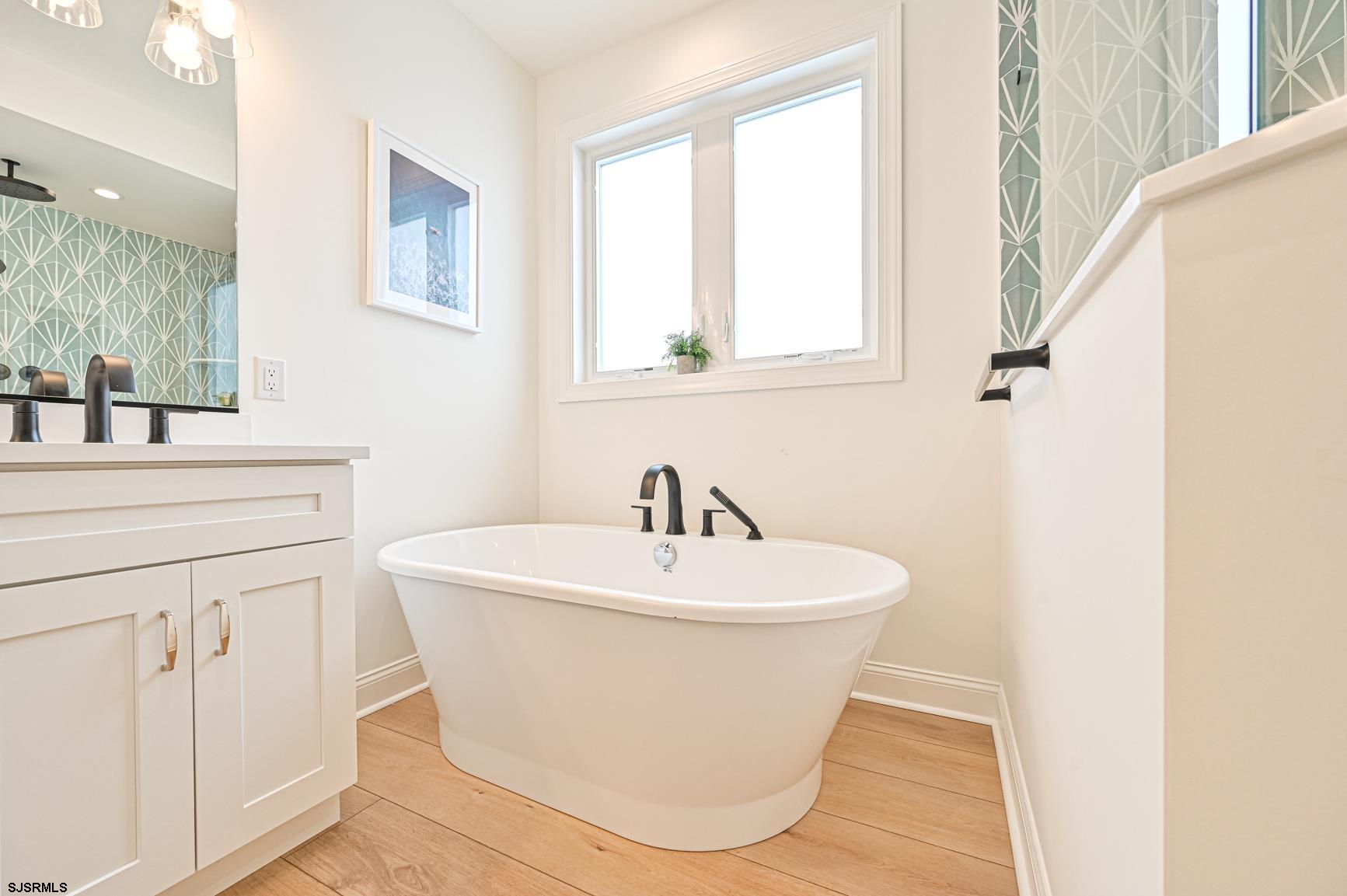 251 38th Street South Brigantine, NJ 08203 - Photo 32 of 63 a white bath tub sitting next to a white sink