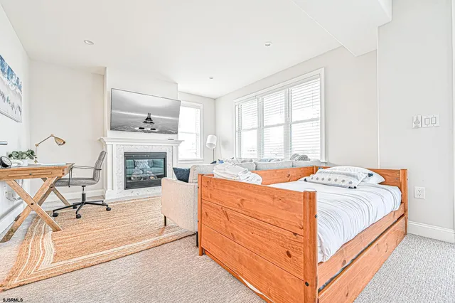 a bedroom with bed and a large window