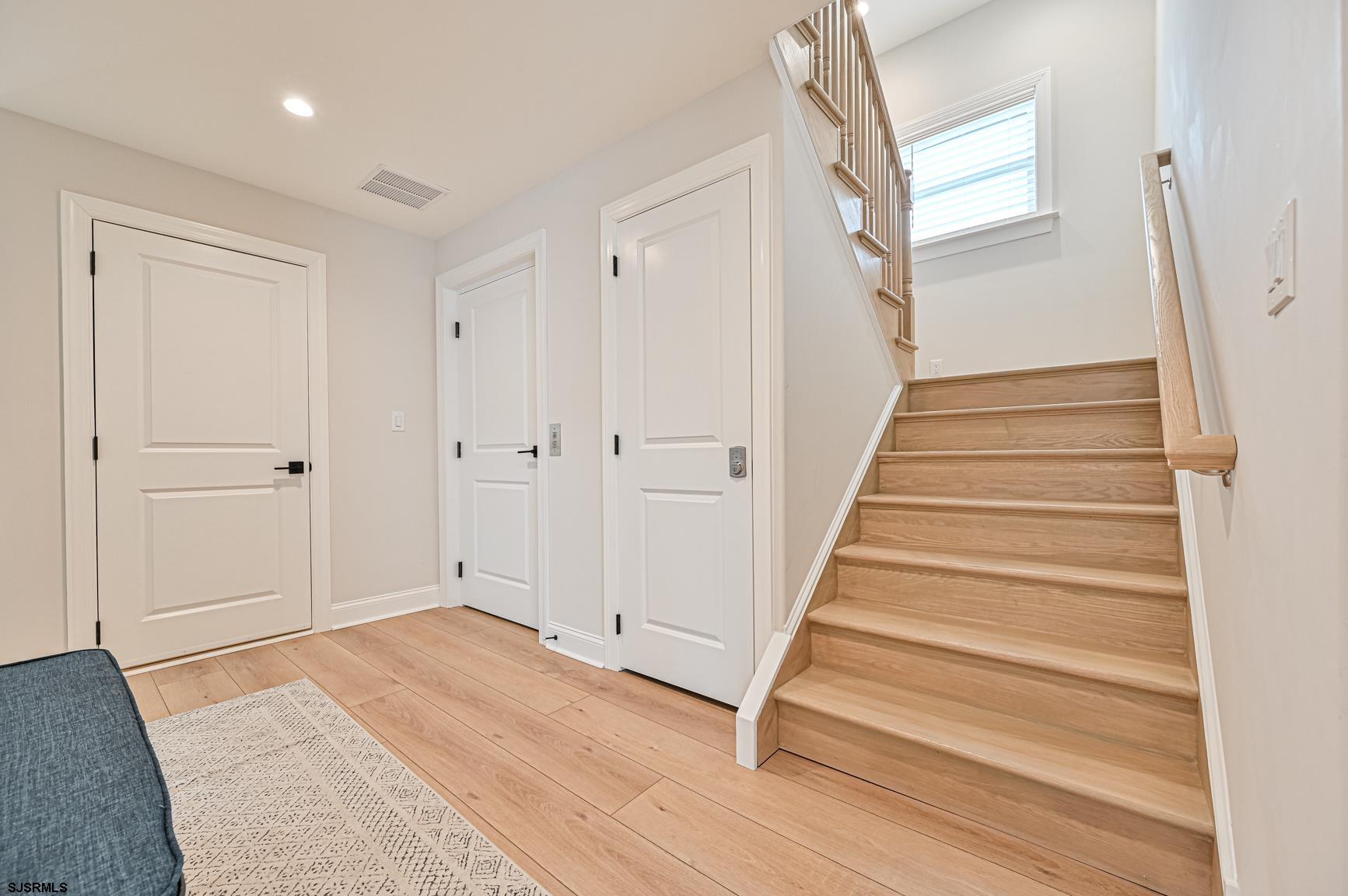 251 38th Street South Brigantine, NJ 08203 - Photo 58 of 63 a view of entryway with wooden floor and stairs