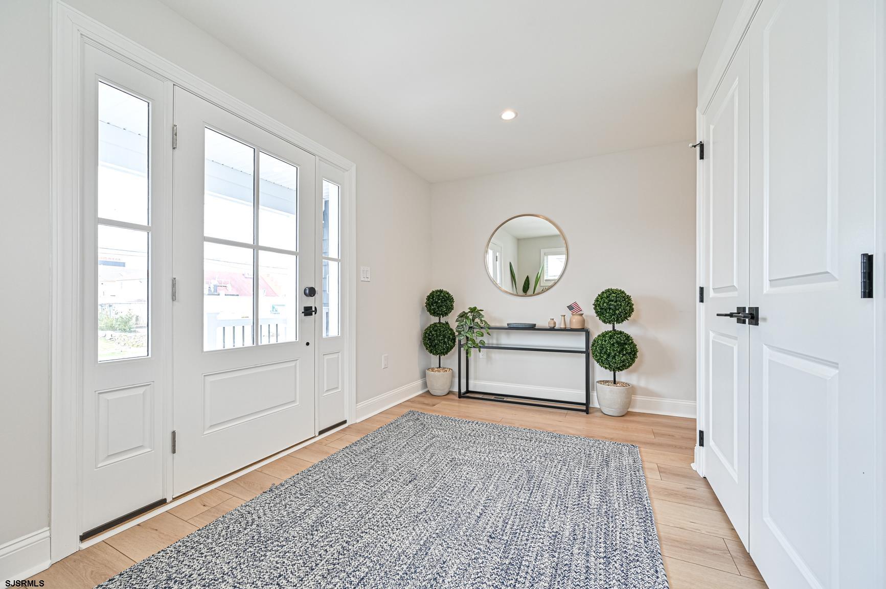251 38th Street South Brigantine, NJ 08203 - Photo 6 of 63 a view of a livingroom with wooden floor and a potted plant