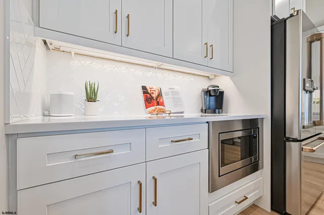 a kitchen with stainless steel appliances granite countertop a sink a stove top oven and cabinets