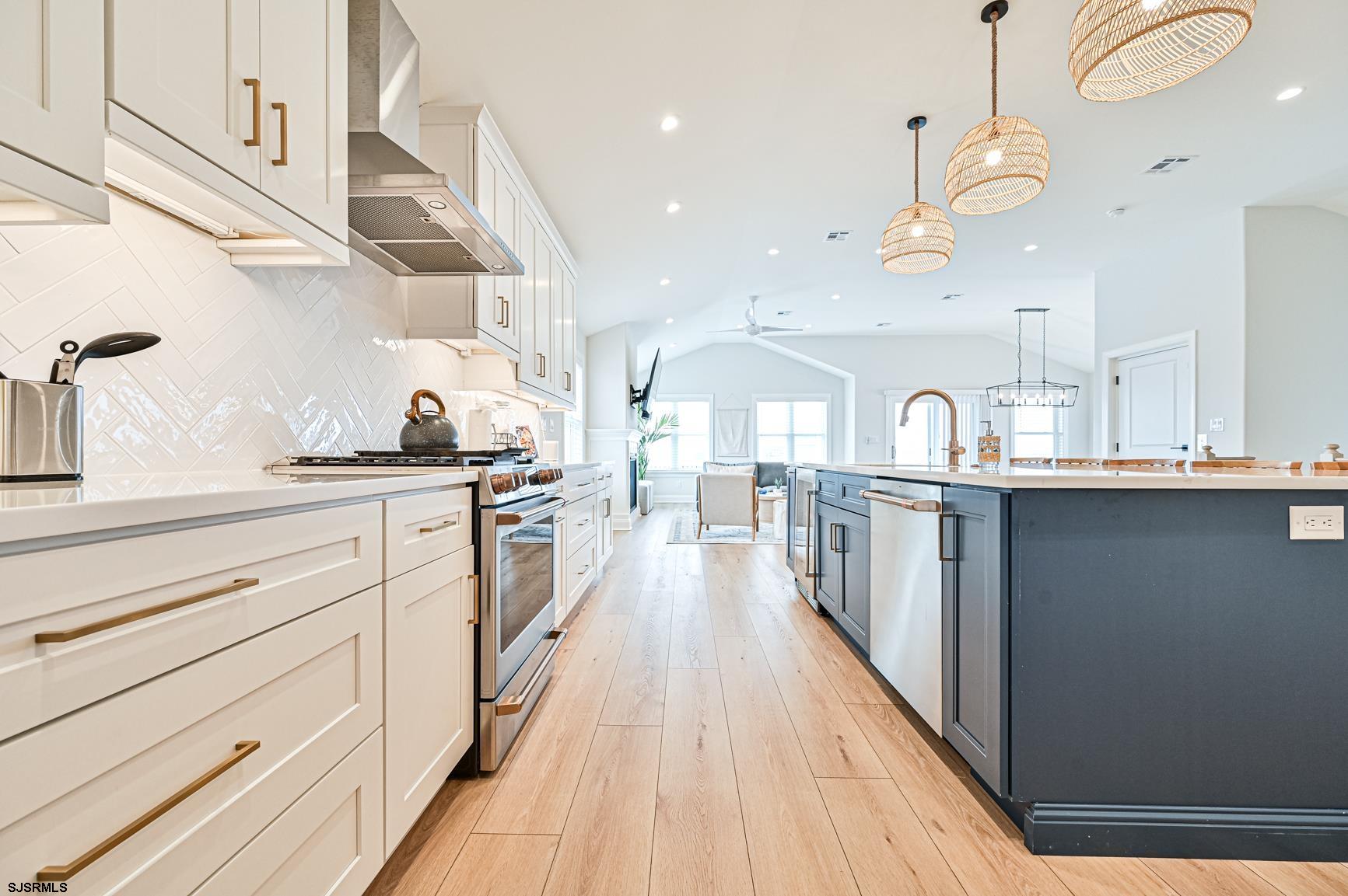 251 38th Street South Brigantine, NJ 08203 - Photo 10 of 63 a kitchen with kitchen island a sink and a stove with wooden floor