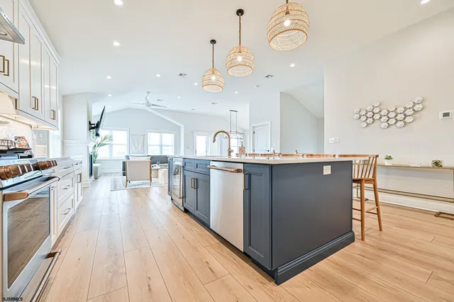 a kitchen with stainless steel appliances a sink stove and refrigerator