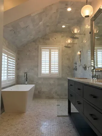 a spacious bathroom with a tub sink and mirror