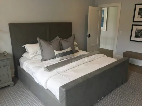 a bedroom with bed and painting on the wall