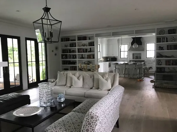a living room with furniture a rug and a chandelier