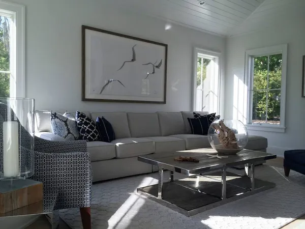 a living room with furniture a window and a potted plant