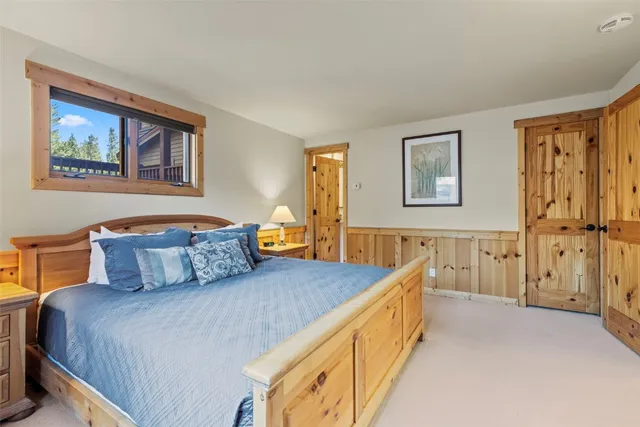 a bedroom with a bed and a painting on the wall