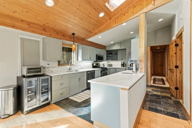 a kitchen with sink a refrigerator and cabinets