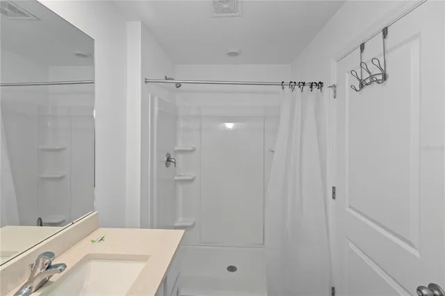 a bathroom with a shower curtain and a sink