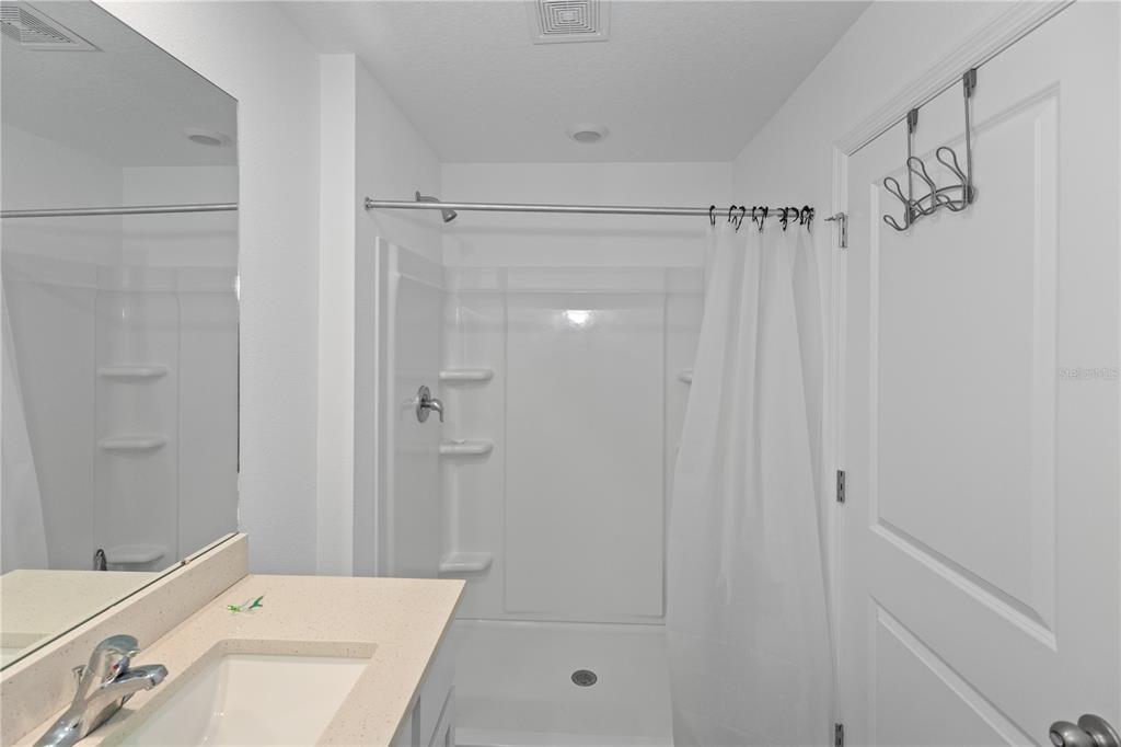 37357 Sharks Eye Lane Zephyrhills, FL 33541 - Photo 11 of 11 a bathroom with a shower curtain and a sink