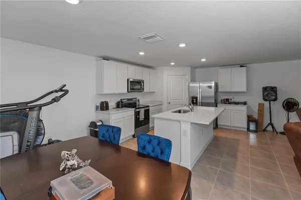 a kitchen with stainless steel appliances granite countertop a refrigerator sink and cabinets