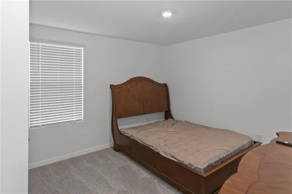 a room with a bed and window