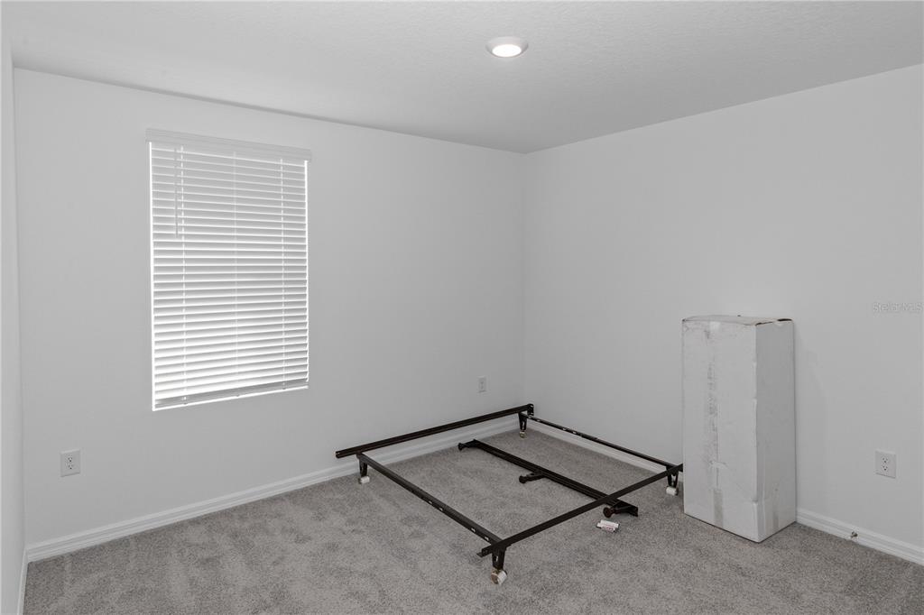 37357 Sharks Eye Lane Zephyrhills, FL 33541 - Photo 6 of 11 a room with a desk and a window