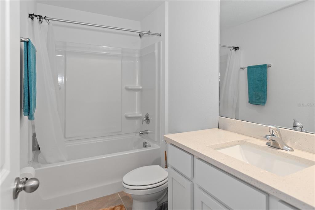 37357 Sharks Eye Lane Zephyrhills, FL 33541 - Photo 9 of 11 a bathroom with a sink toilet and shower