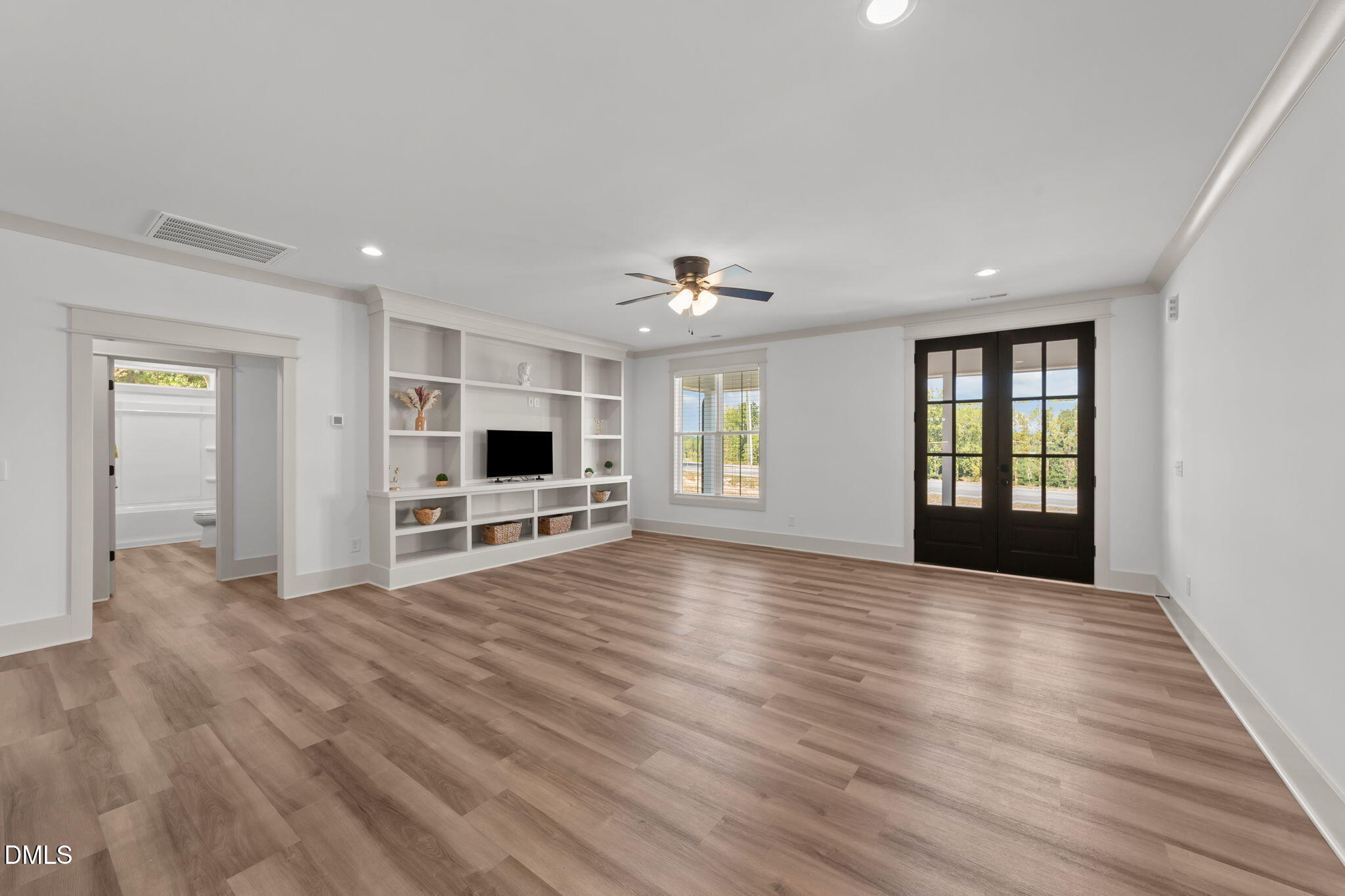 582 Harnett Central Road Fuquay-Varina, NC 27526 - Photo 23 of 51 a view of a livingroom with wooden floor and kitchen space