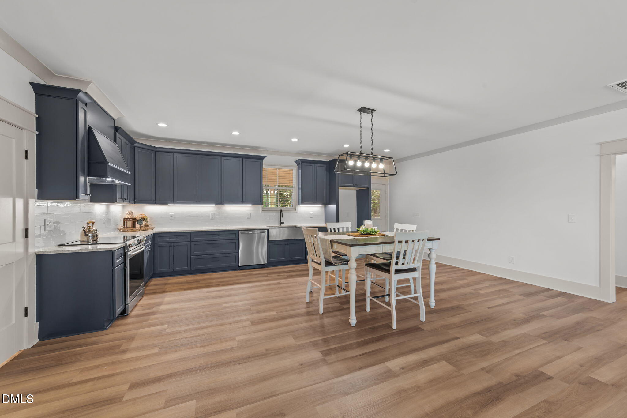 582 Harnett Central Road Fuquay-Varina, NC 27526 - Photo 26 of 51 a large kitchen with a table and chairs